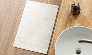 Tapis de bain : Découvrez notre guide ultime pour bien le choisir ! Tapis blanc près d’un lavabo moderne
